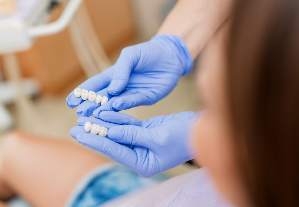 Dentist showing dental crowns to a patient