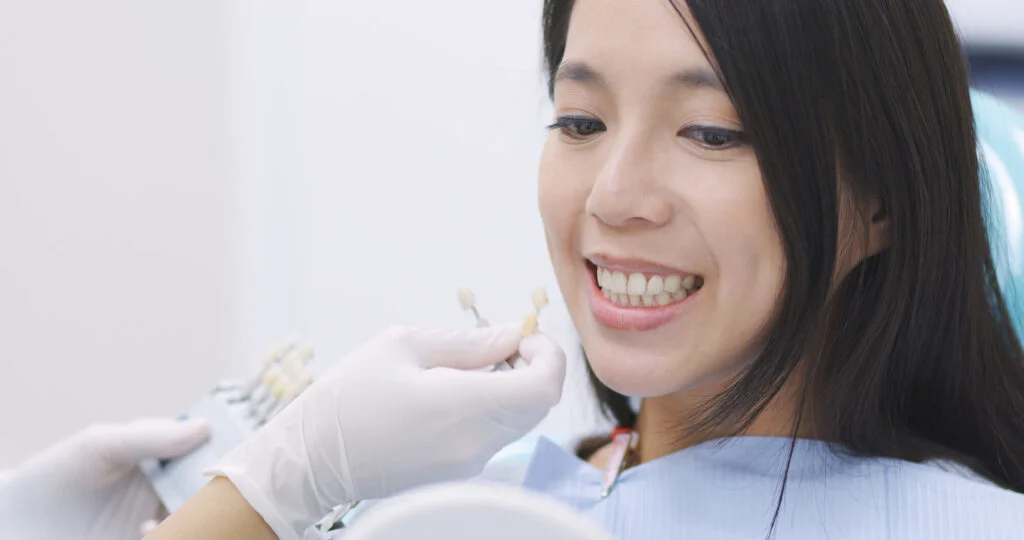 Dentist with a woman patient during a dental crown appointment